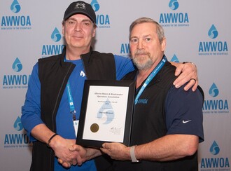 Darrin Wenzel, 2023 Ron Bayne Service Award Recipient, Presented by AWWOA Chair, Mike Bureaud